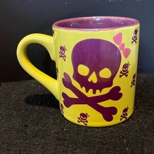 David & Goliath 12oz mug featuring a purple skull and crossbones design